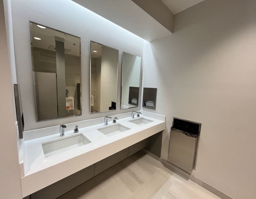 Modern commercial restroom renovation in Weston, FL featuring updated sinks, mirrors, and premium finishes. Professional upgrade by GQM Inc.