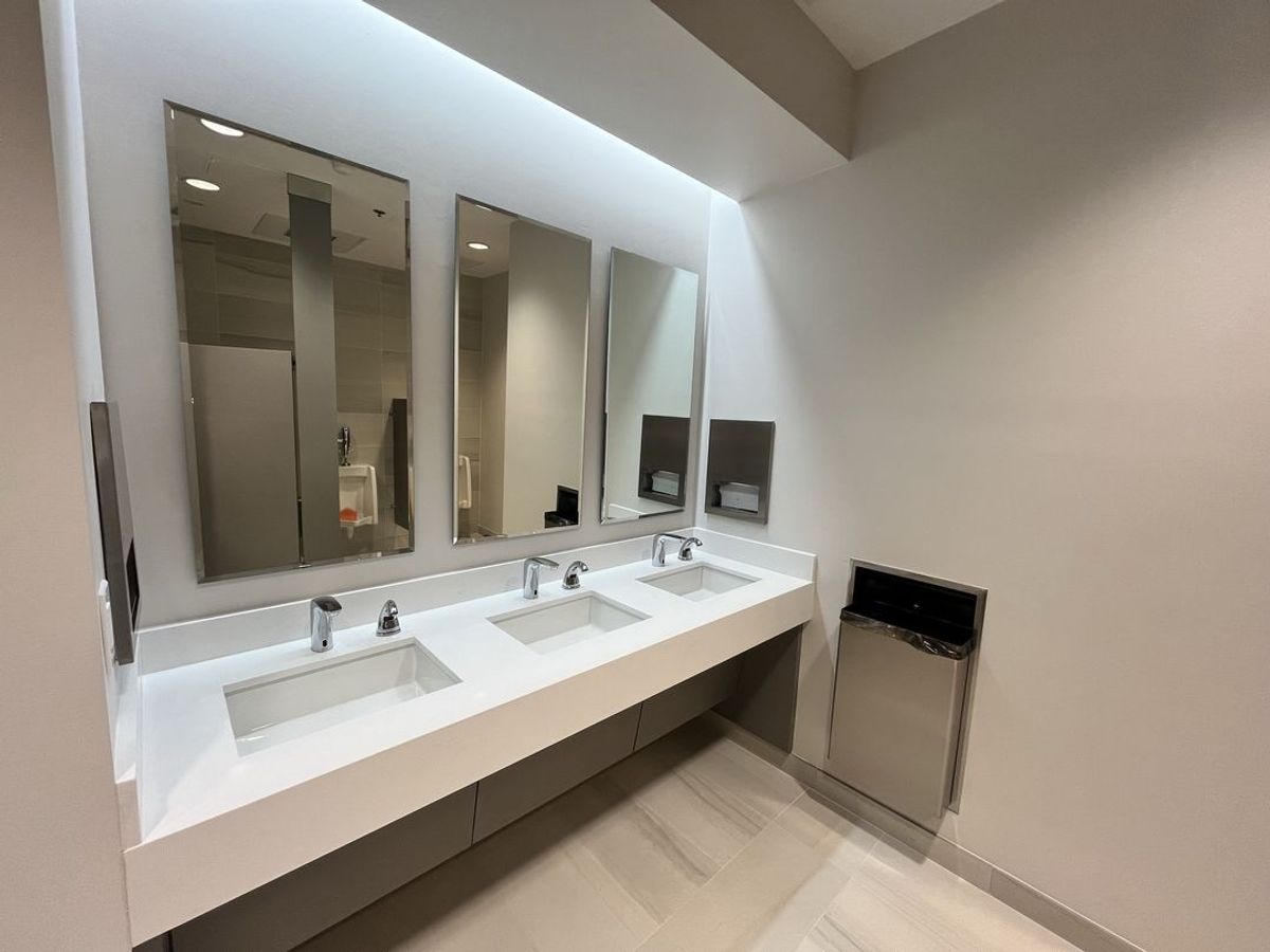 Modern commercial restroom renovation in Weston, FL featuring updated sinks, mirrors, and premium finishes. Professional upgrade by GQM Inc.