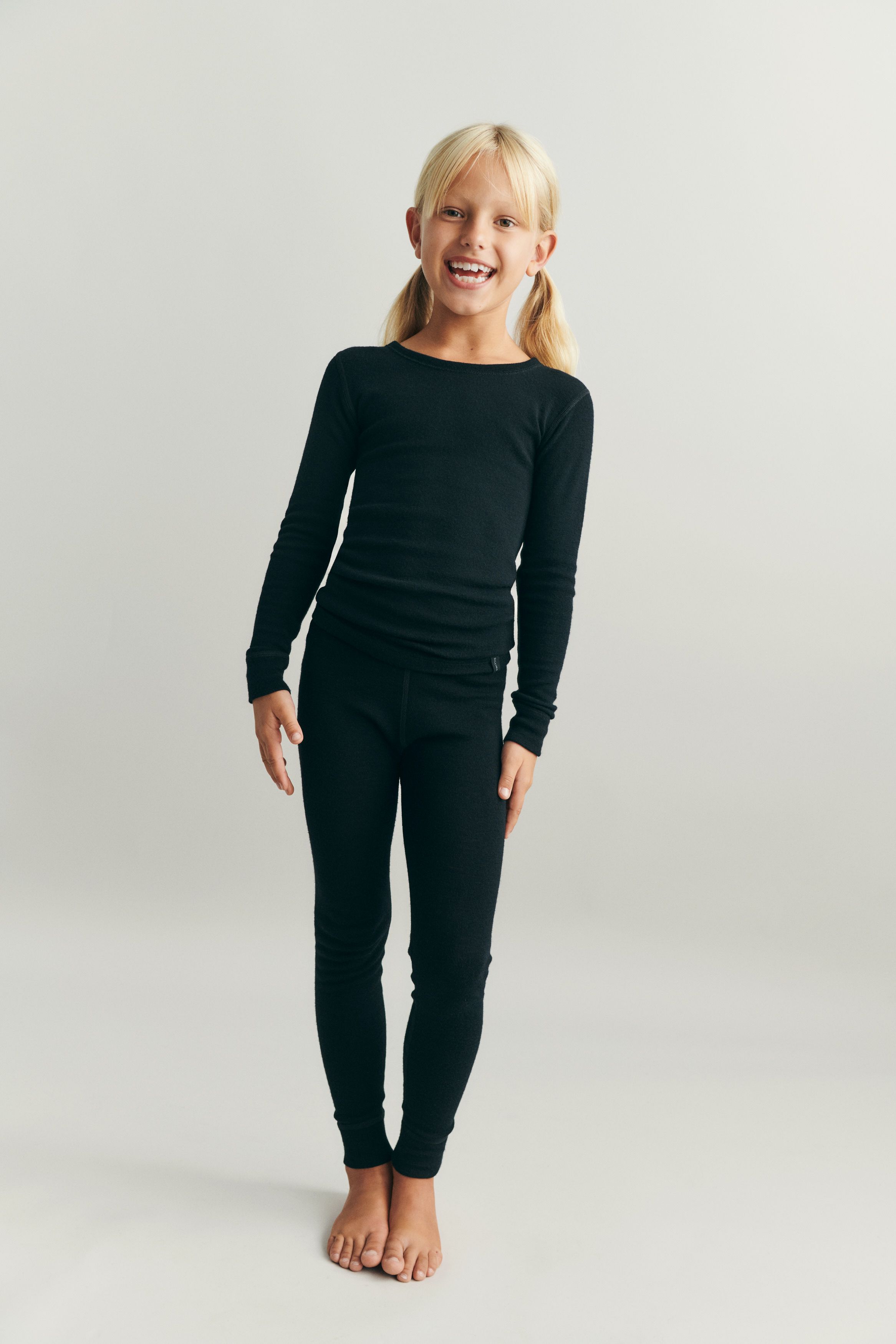 Child standing in DILLING clothes