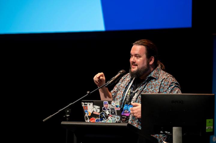 A speaker at the lectern at Latency 2021