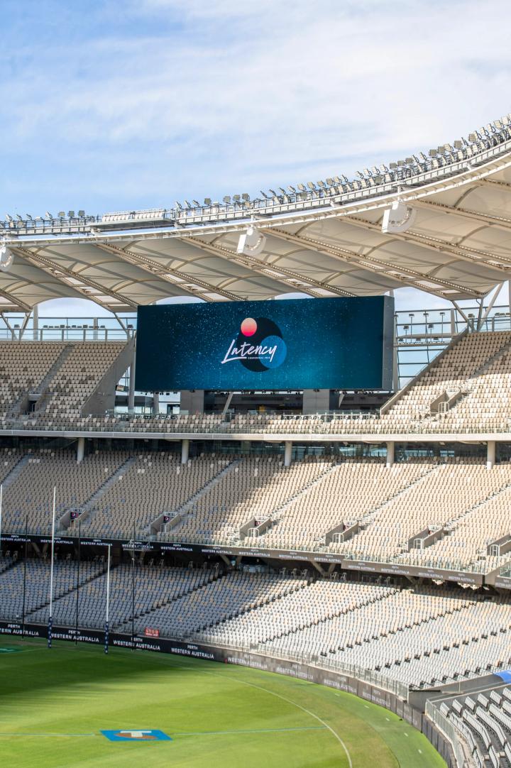 The Latency logo on the big screen at Optus Stadium in 2023