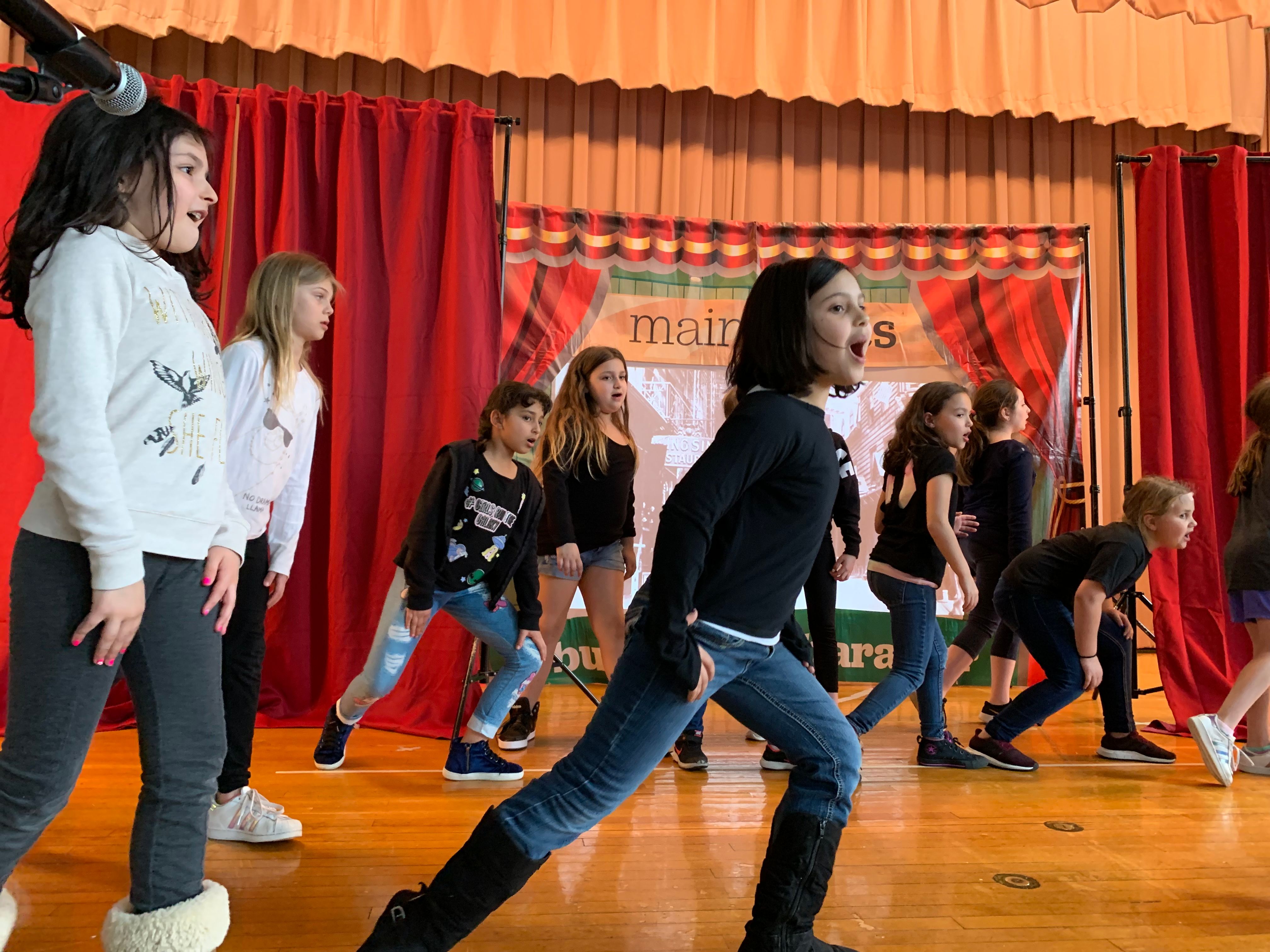children on stage performing
