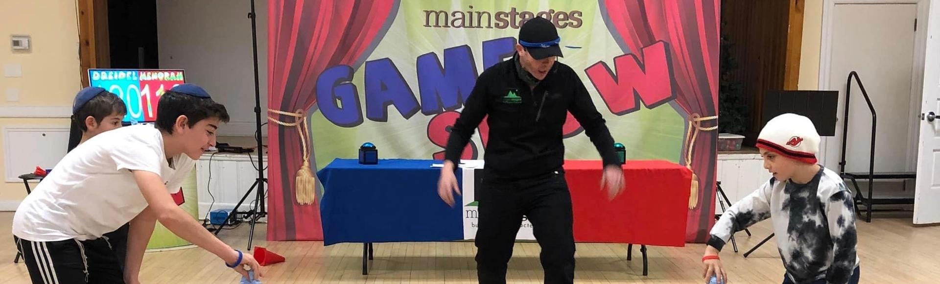 Kids standing behind buzzers