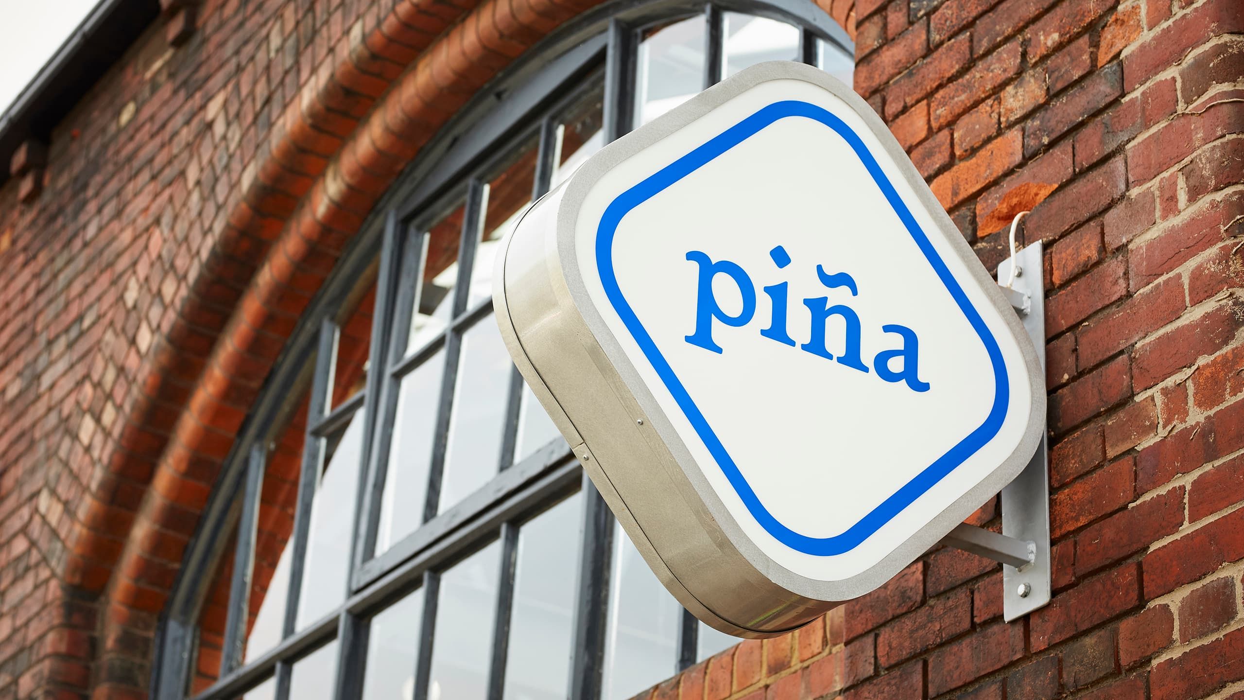 The illuminating sign on the façade of piña, Sheffield.