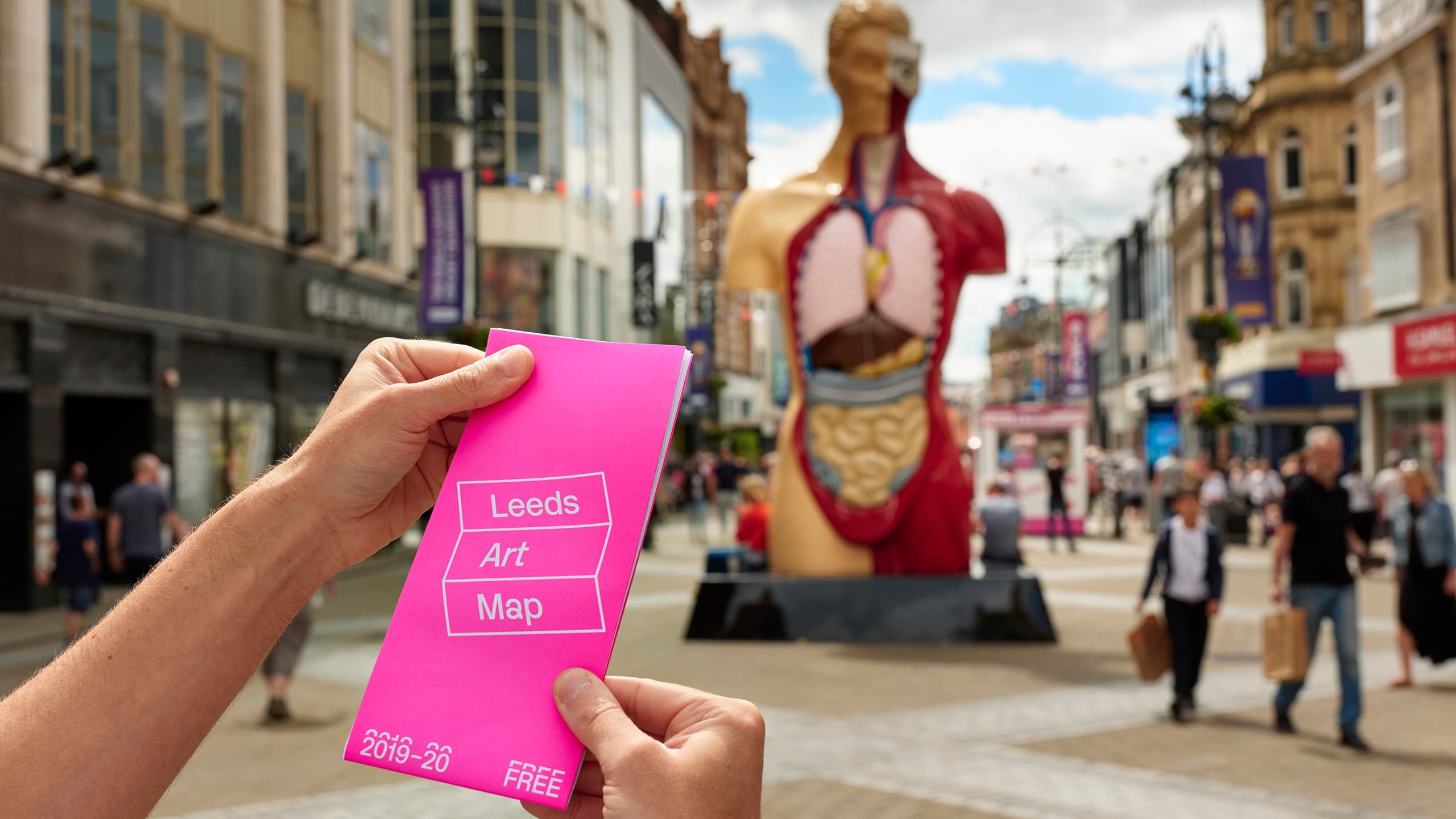 Leeds Art Map in use with Damien Hirst's Hymn sculpture in the background.