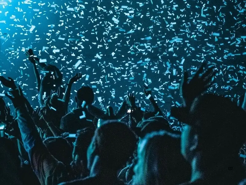 massive crowd of music fans with hands raised during a confetti drop at a headline set, featured in the MedSailors 2026 Europe festival guide.
