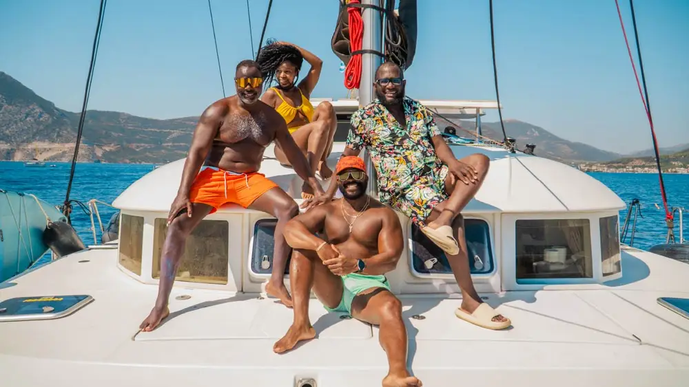 Group of friends on an economy catamaran