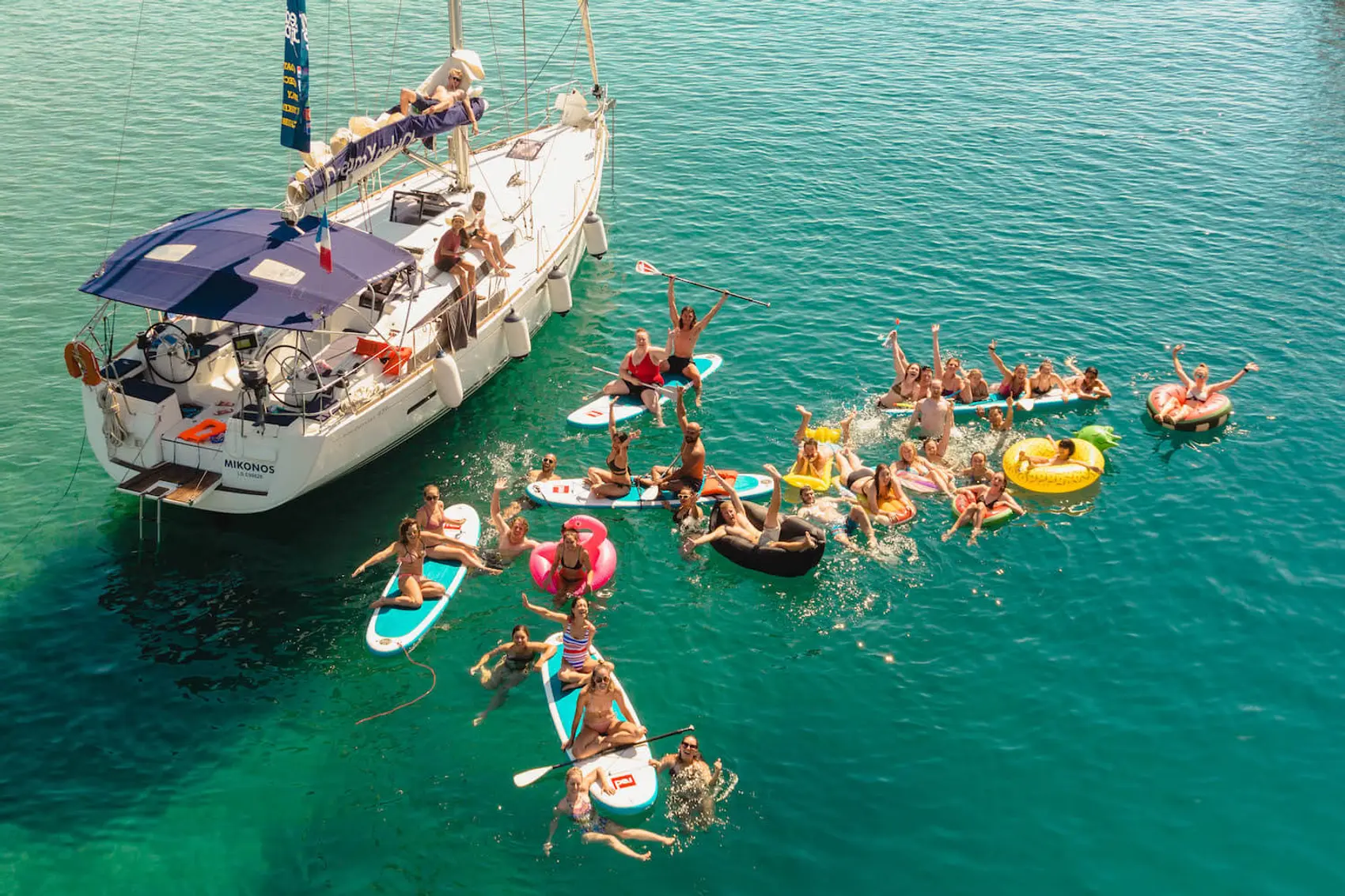 Guests swimming next to a MedSailors yacht