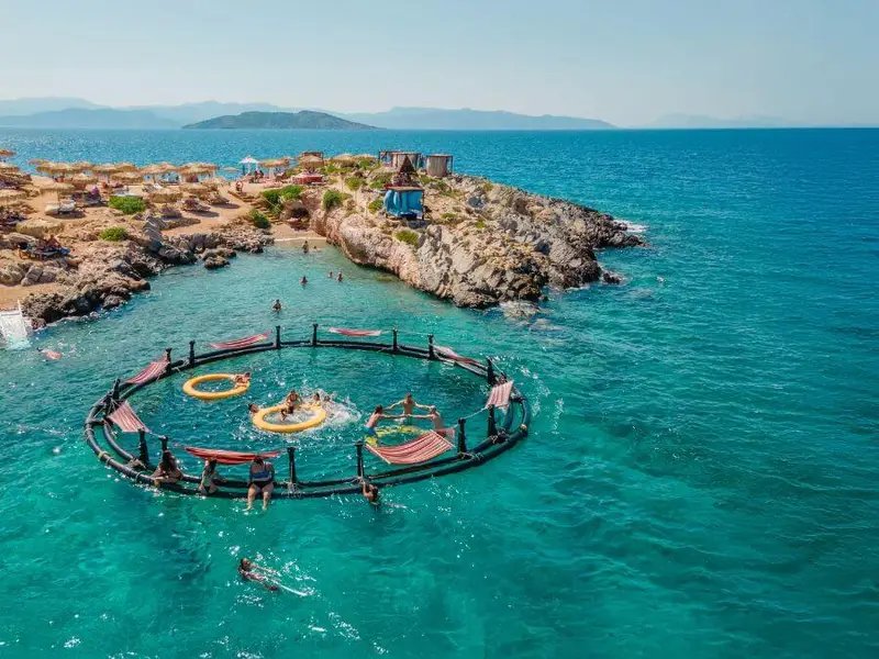  dreamy floating lounge setup in turquoise waters on Agistri, offering the ultimate Mediterranean escape, highlighting Greece’s best beach destinations, from secluded coves to famous island hotspots.