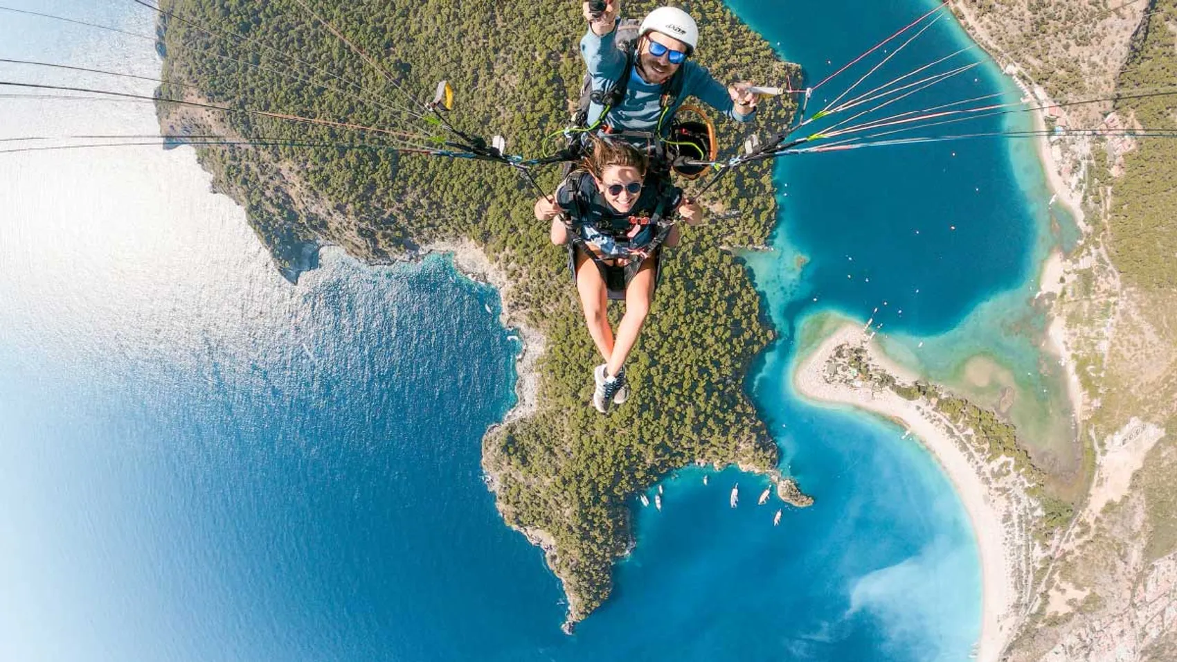 Person paragliding over Oludeniz beach