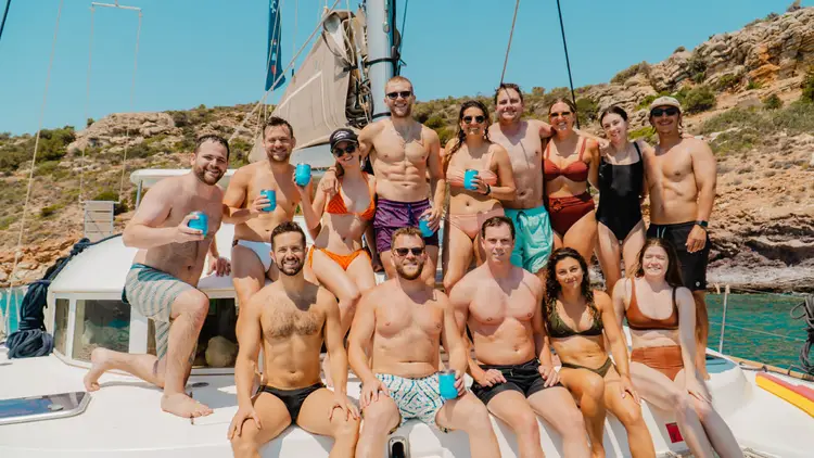 Group of guests pose for a photo on a yacht