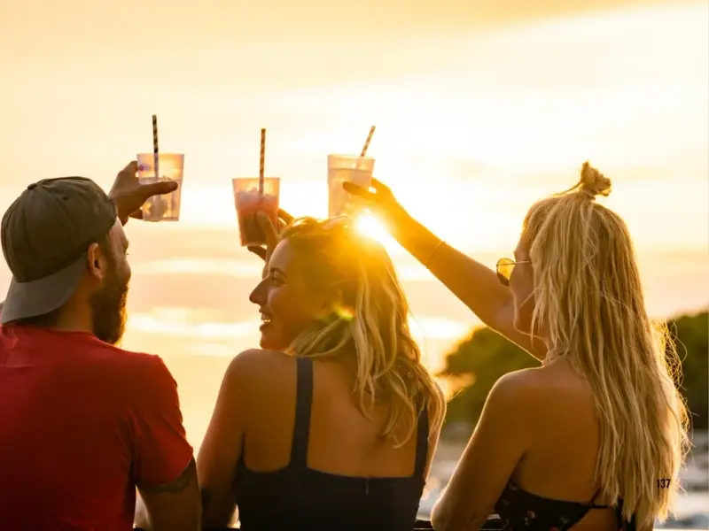 Travellers enjoying sunset drinks by the water in Croatia during a warm summer evening. A strong lifestyle image for content about ULTRA Europe, Croatia island hopping, Split nightlife, and building a bigger summer trip around the festival rather than just the main event.