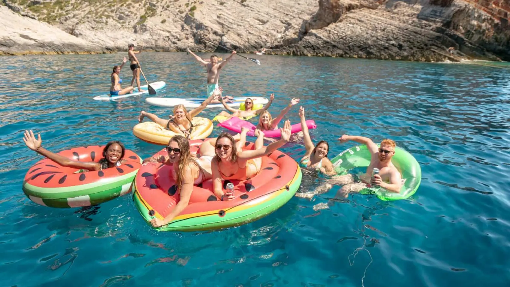 Group of friends on floaties in Greece