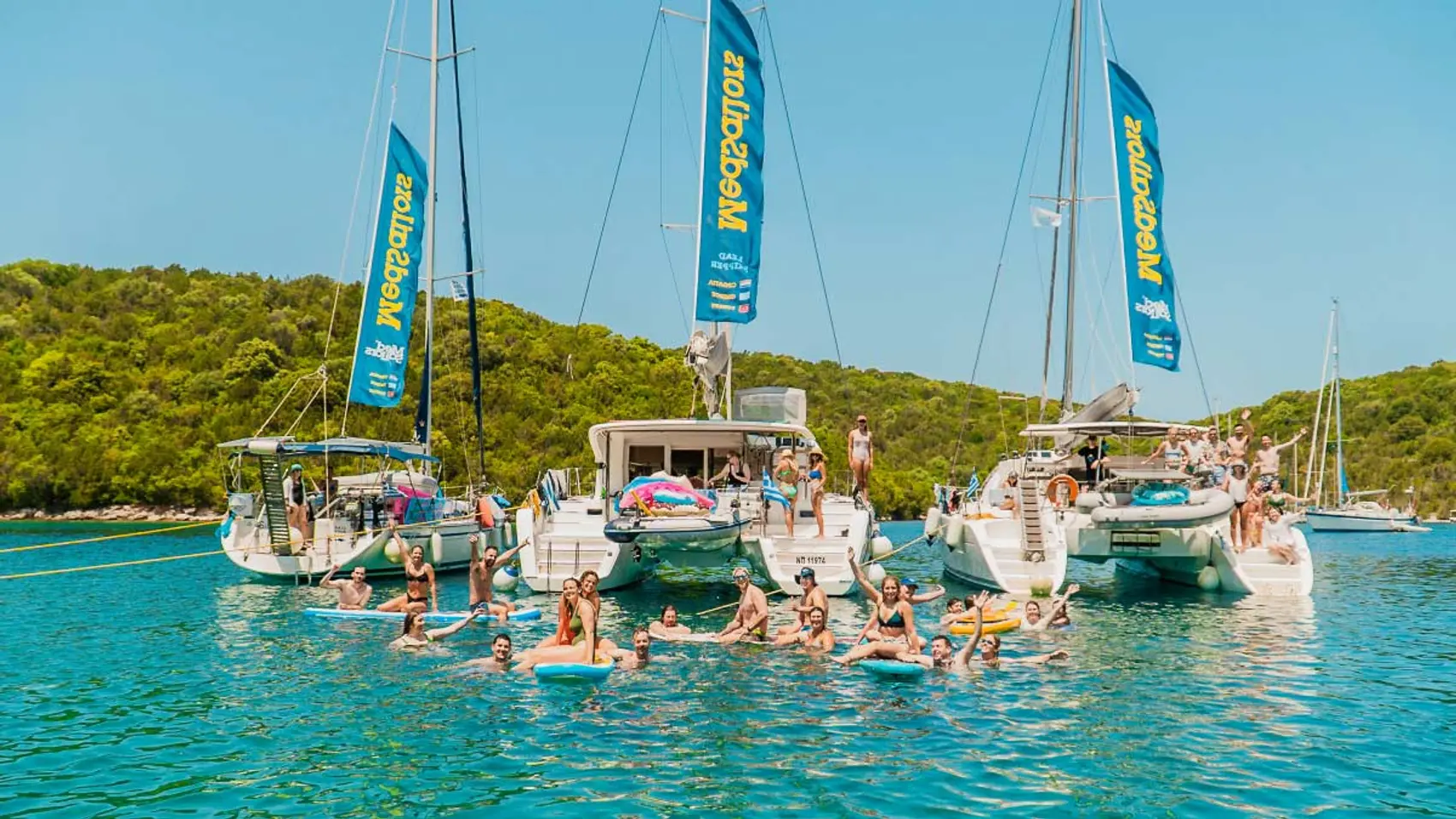 Three MedSailors yachts anchored together in a bay