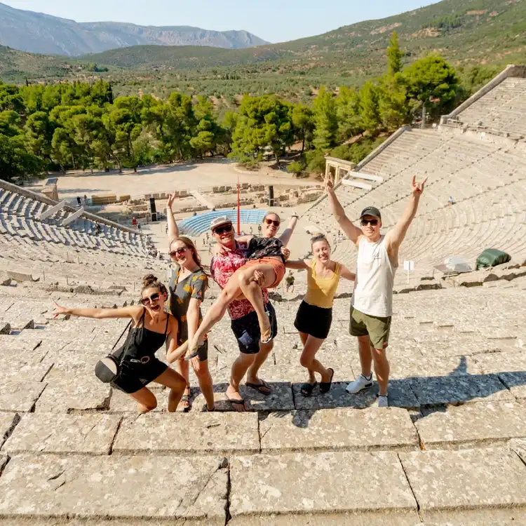 Group of people explore the Epidavros ruins in Greece