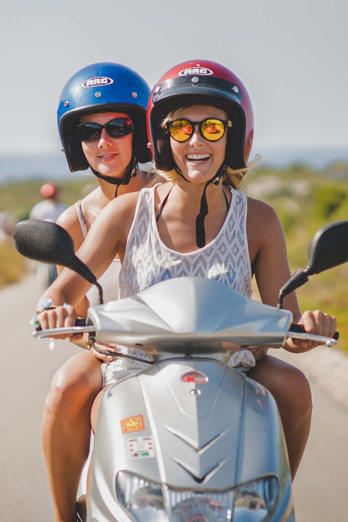 Friends riding a scooter in Croatia