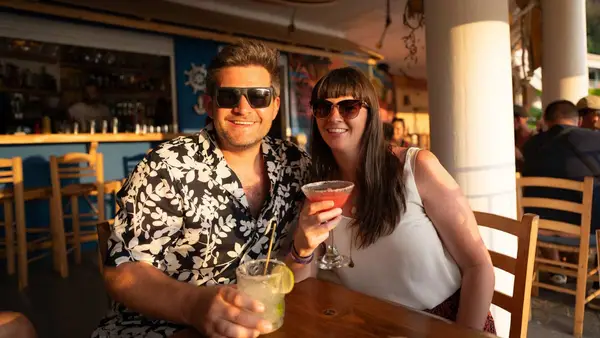Couple have a cocktail at sunset