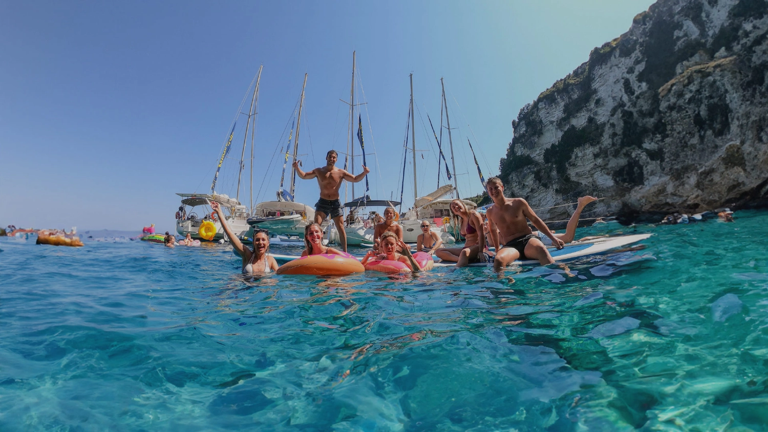 MedSailors guests posing for a photo in the water