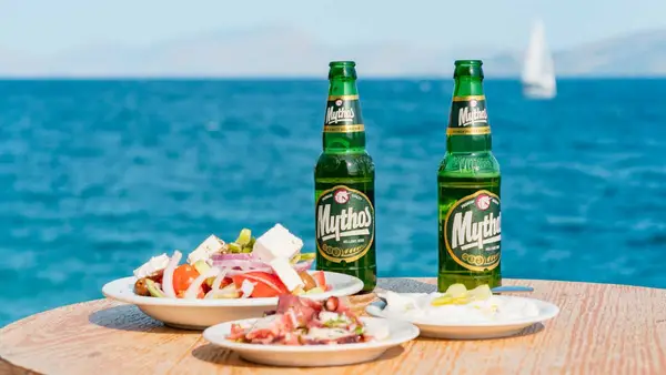 Bottles of Mythos beer and a Greek salad