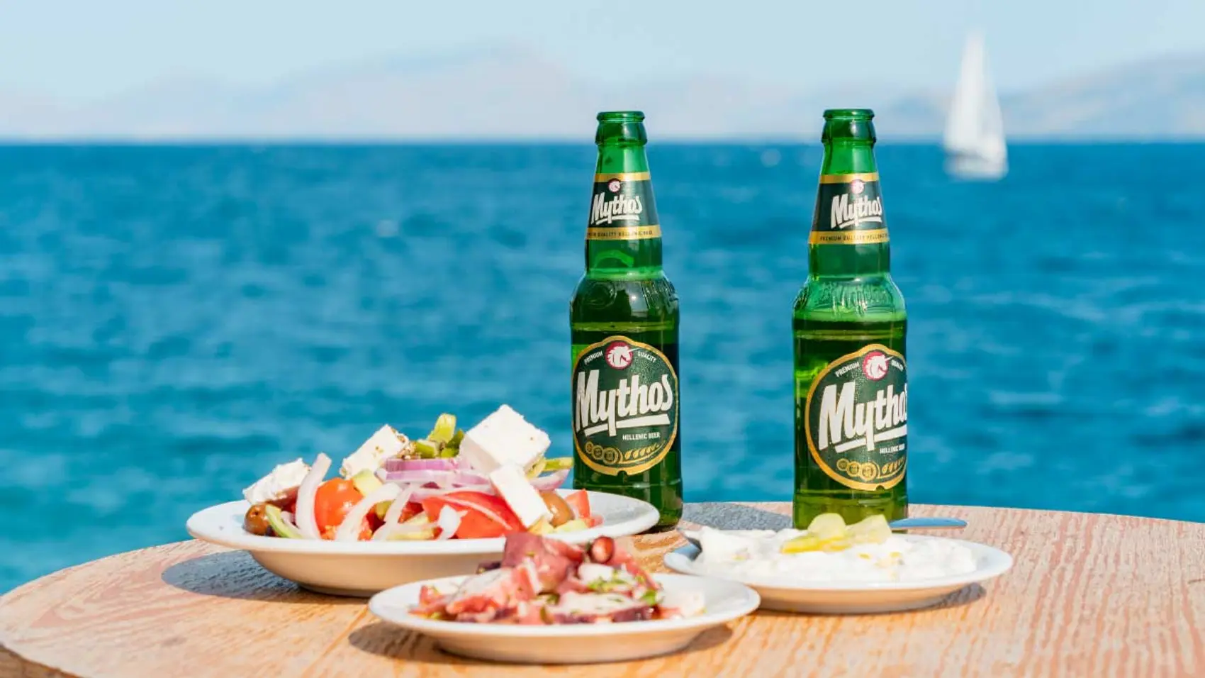 Bottles of Mythos beer and a Greek salad