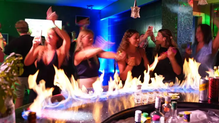 MedSailors travellers dancing at a lively cocktail bar in Ermioni, Greece.