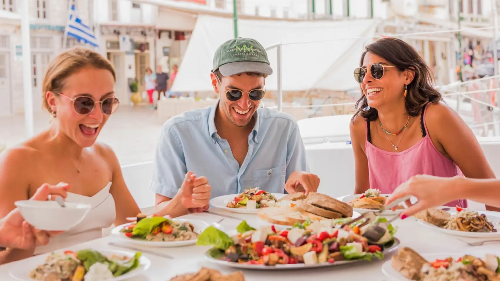 Group of friends eating some Greek food