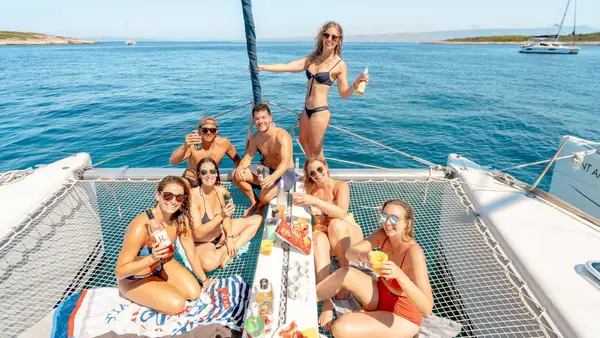 Group of friends drinking on a catamaran
