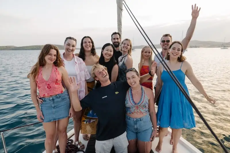 A group of MedSailors travellers aged 18–35 smiling on the deck of a yacht during a Croatia island hopping sailing holiday.