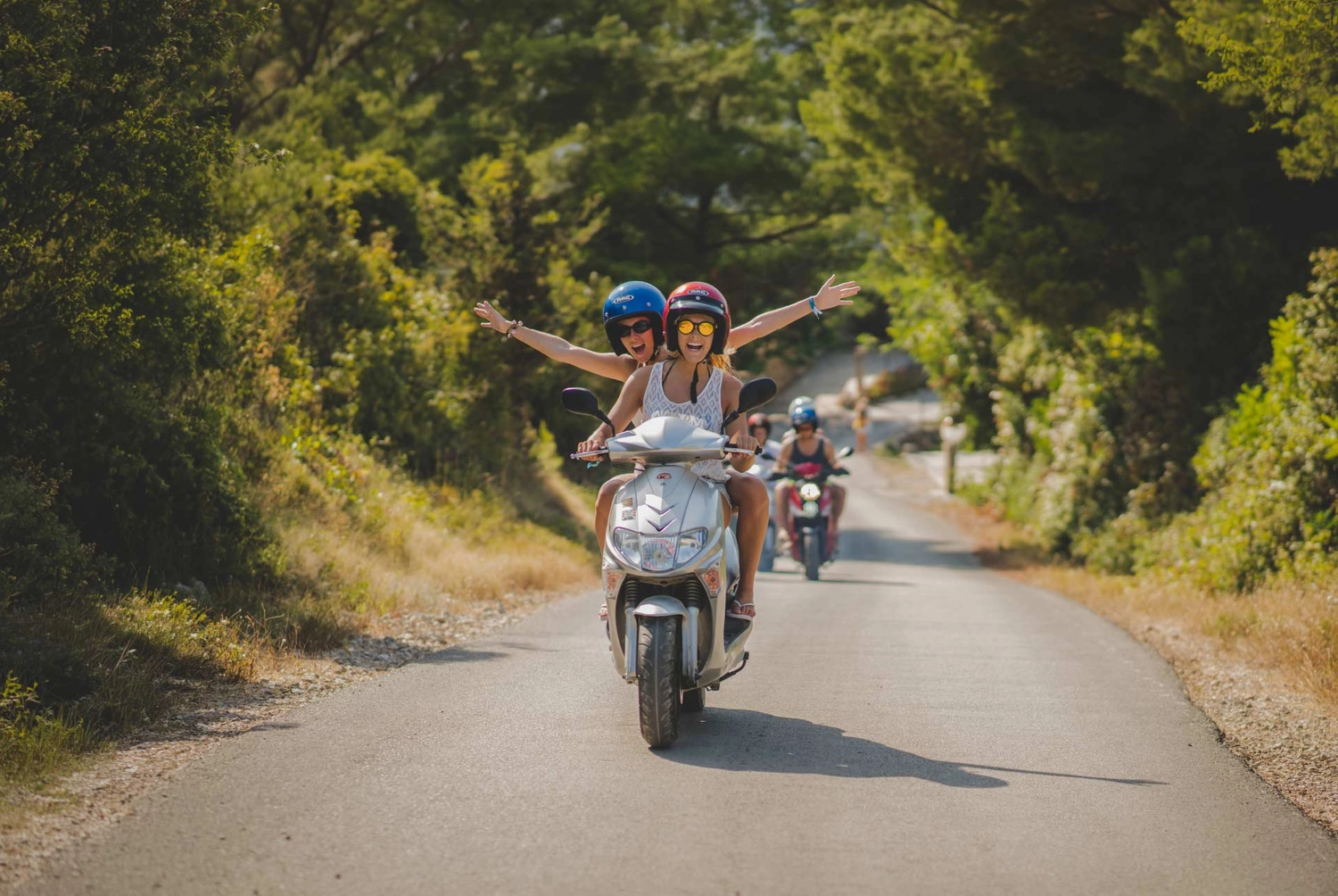 Two women on a scooter