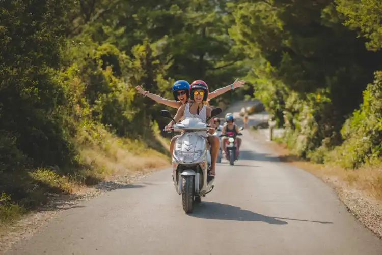 Two women on a scooter