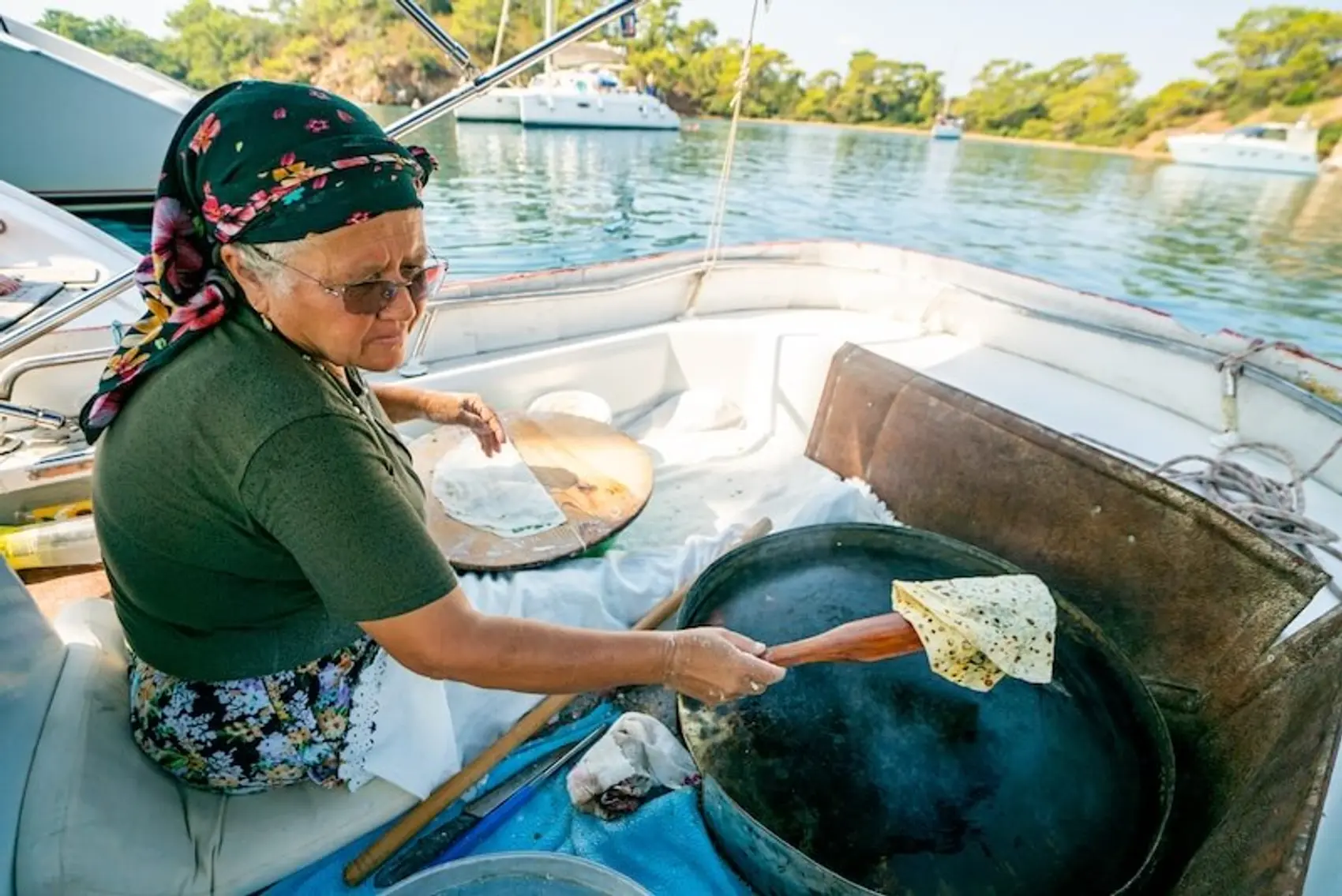 A lady on a pancake boat in Turkey makes traditional gozleme.