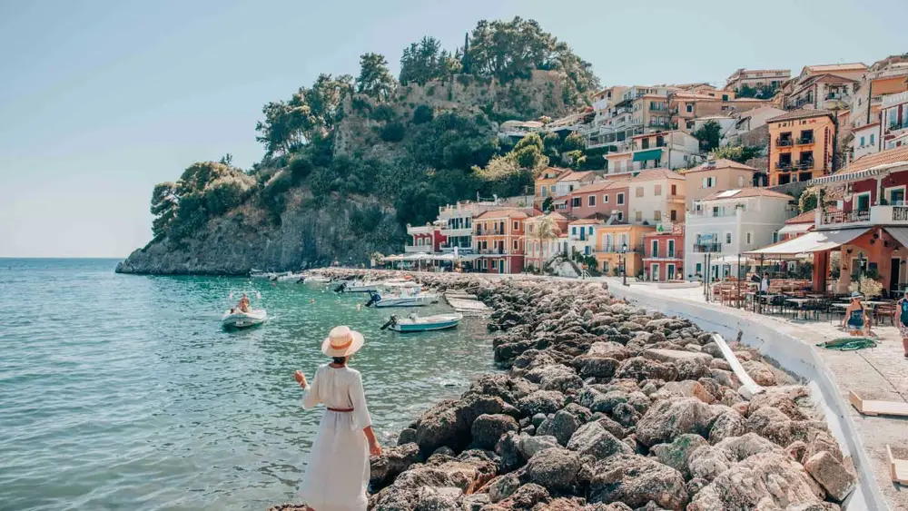 Woman walking along the waterfront of Parga town