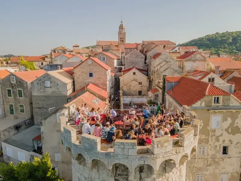 Aerial drone photo of Korcula Old Town and Massimo cocktail bar on a fortress, which is an amazing alternative for partying besides Magaluf and Ibiza.