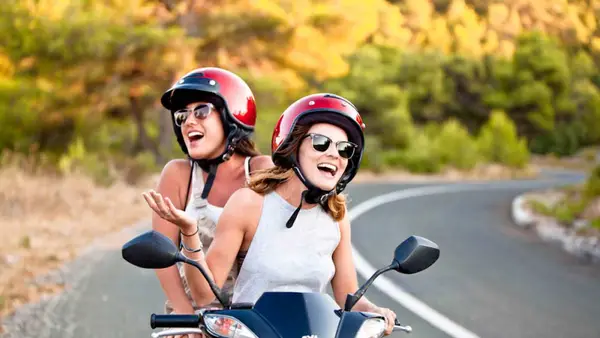 Two women on a scooter in Vis