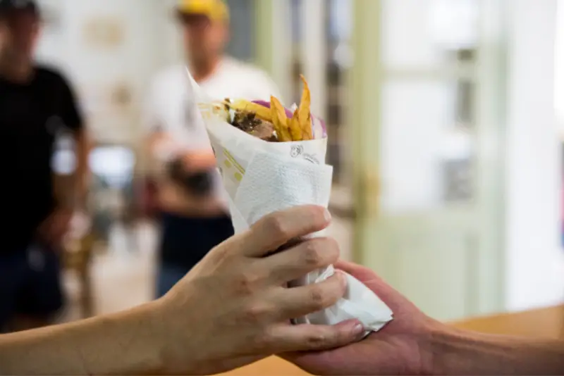 Person handing a gyros to another person