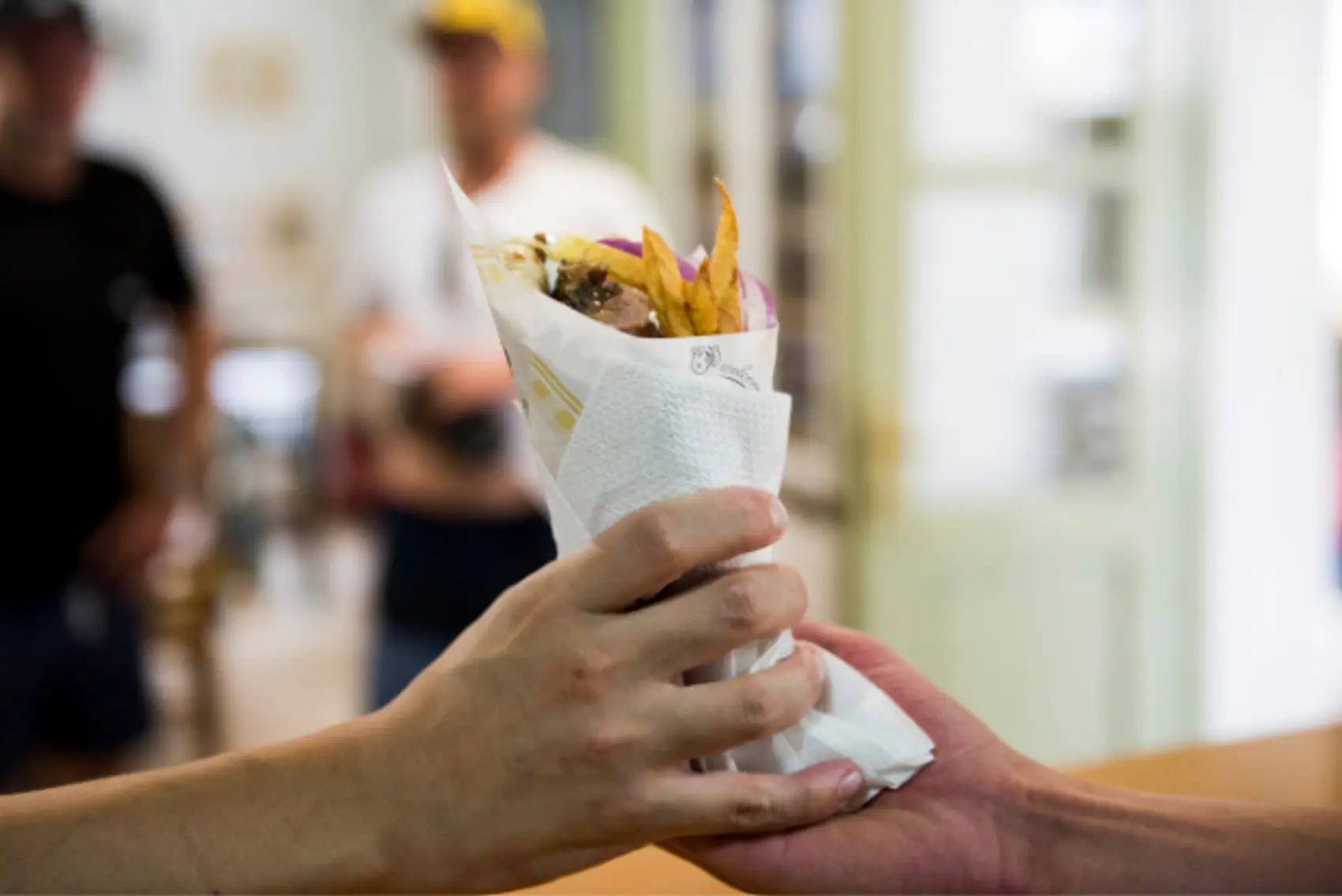 Person handing a gyros to another person