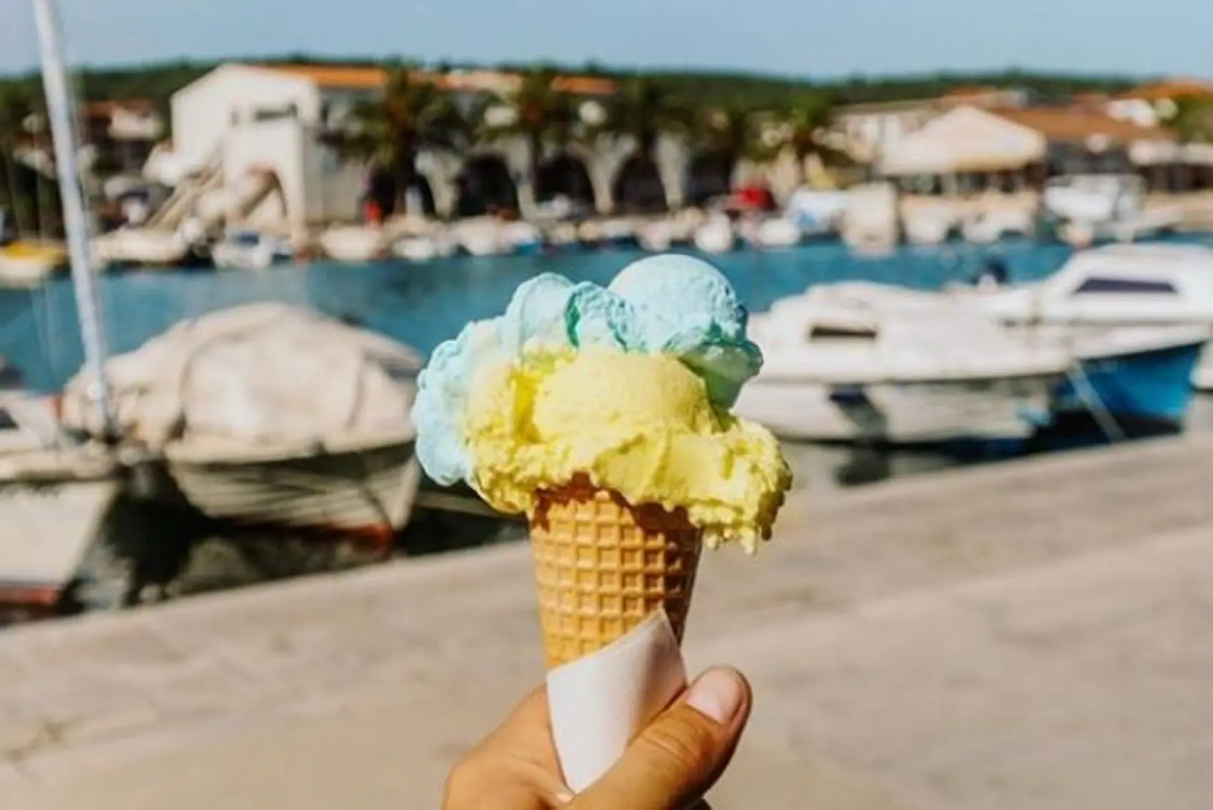 Hand holding ice-cream in waffle cone