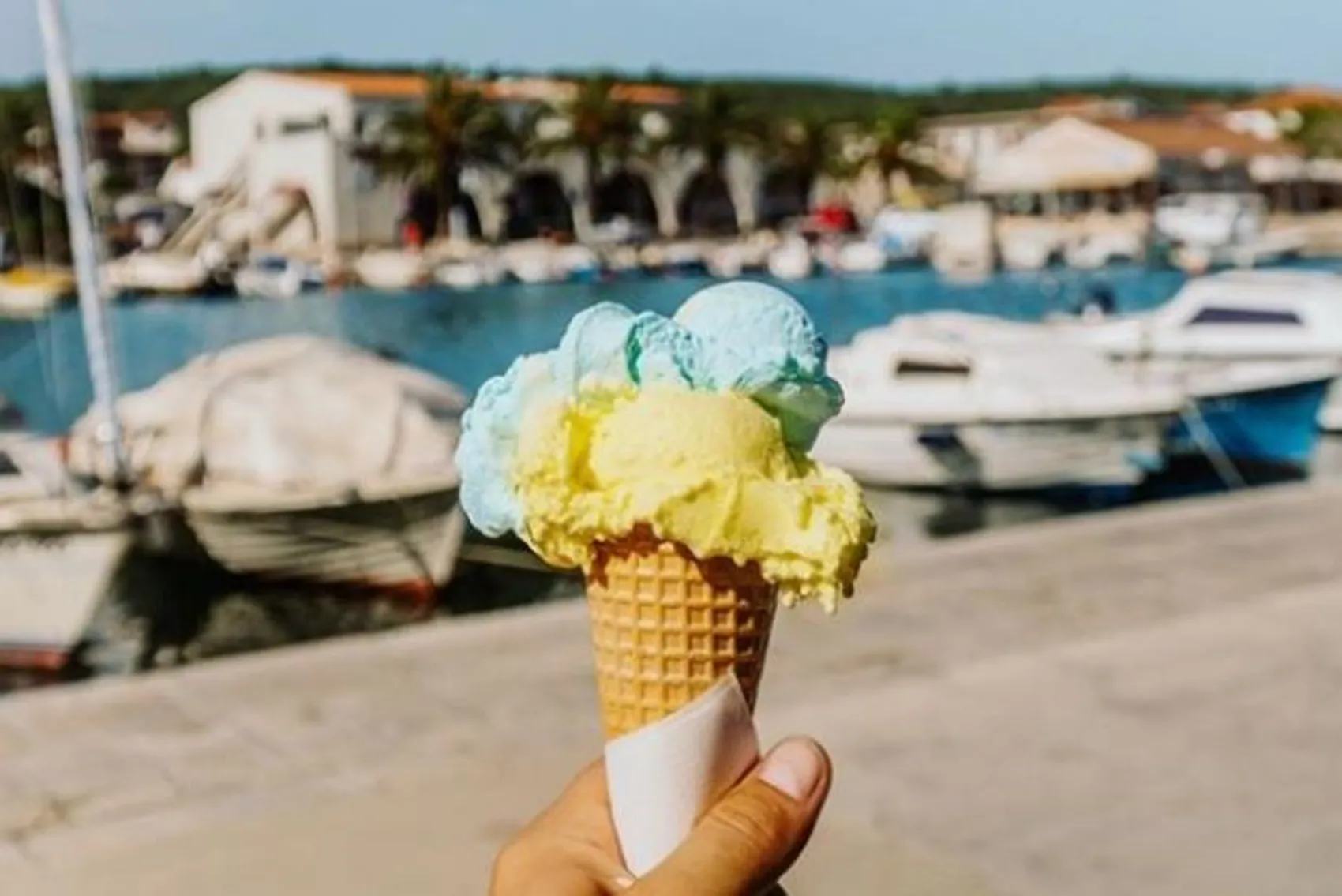 Hand holding ice-cream in waffle cone