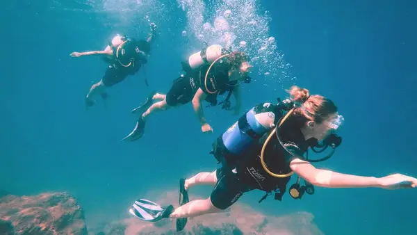 A group of travellers scuba diving off of Agistri island in the Saronic Gulf near Athens, one of the most beautiful scuba diving spots in Greece.