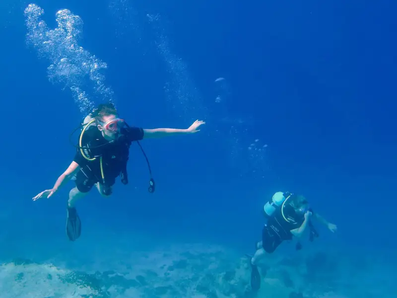 Photo of people scuba diving in Greece. Photo by Ryan Brown of Lostboymemoirs.com