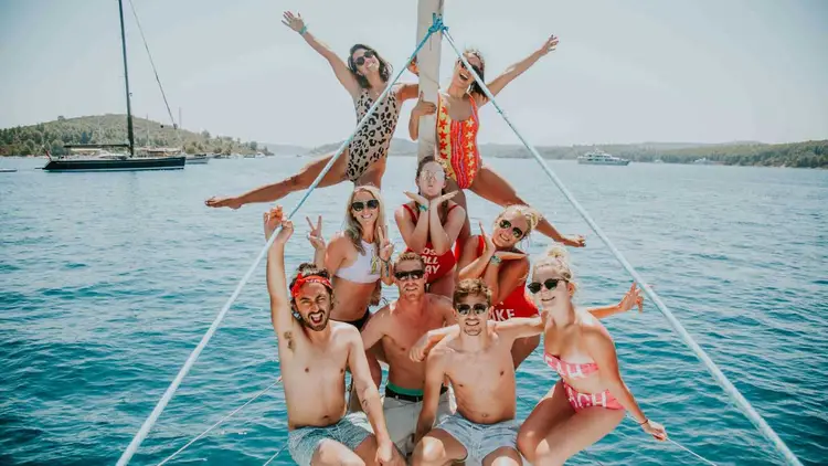 Group posing for a photo on a MedSailors yacht