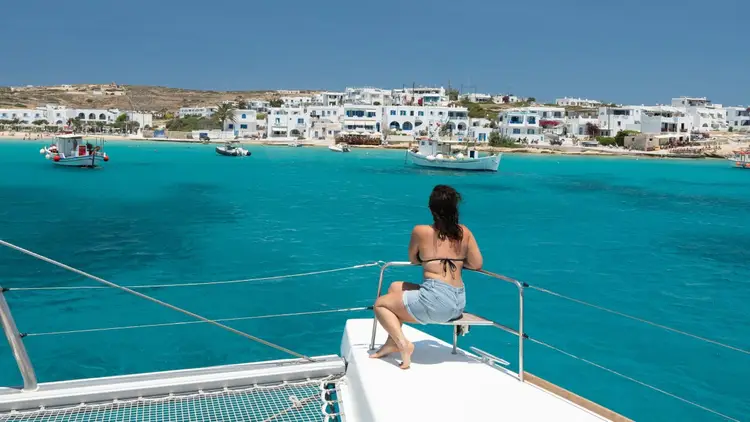 Group of people swim in blue water in Greece