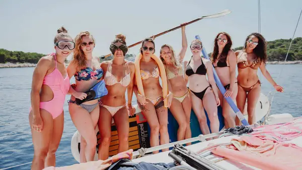 Group of women posing for a photo on a yacht