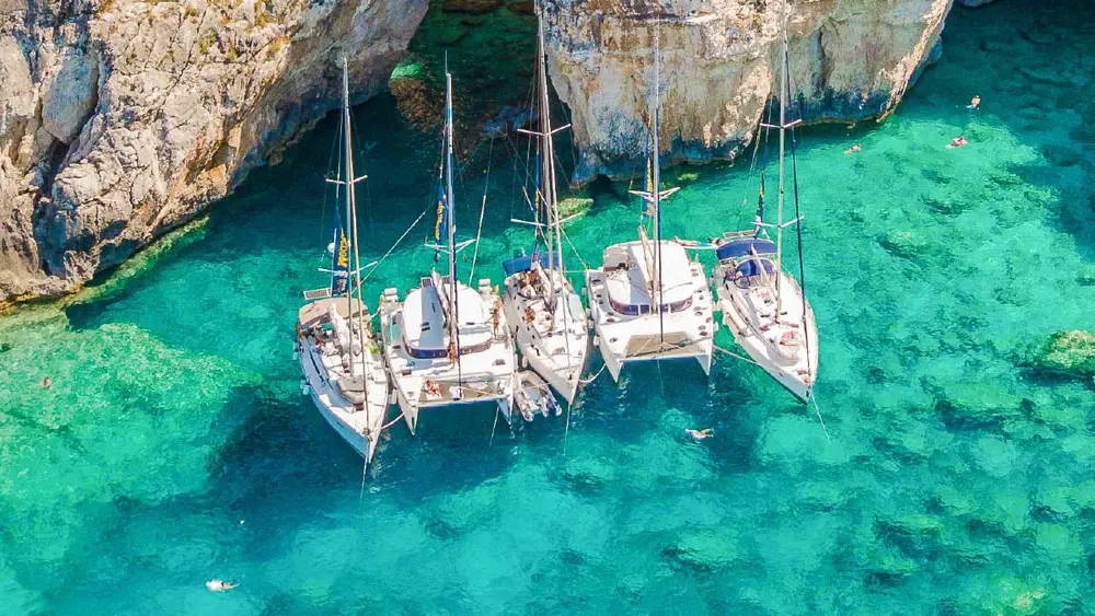 Corfu blue caves and yachts at anchor in front of them