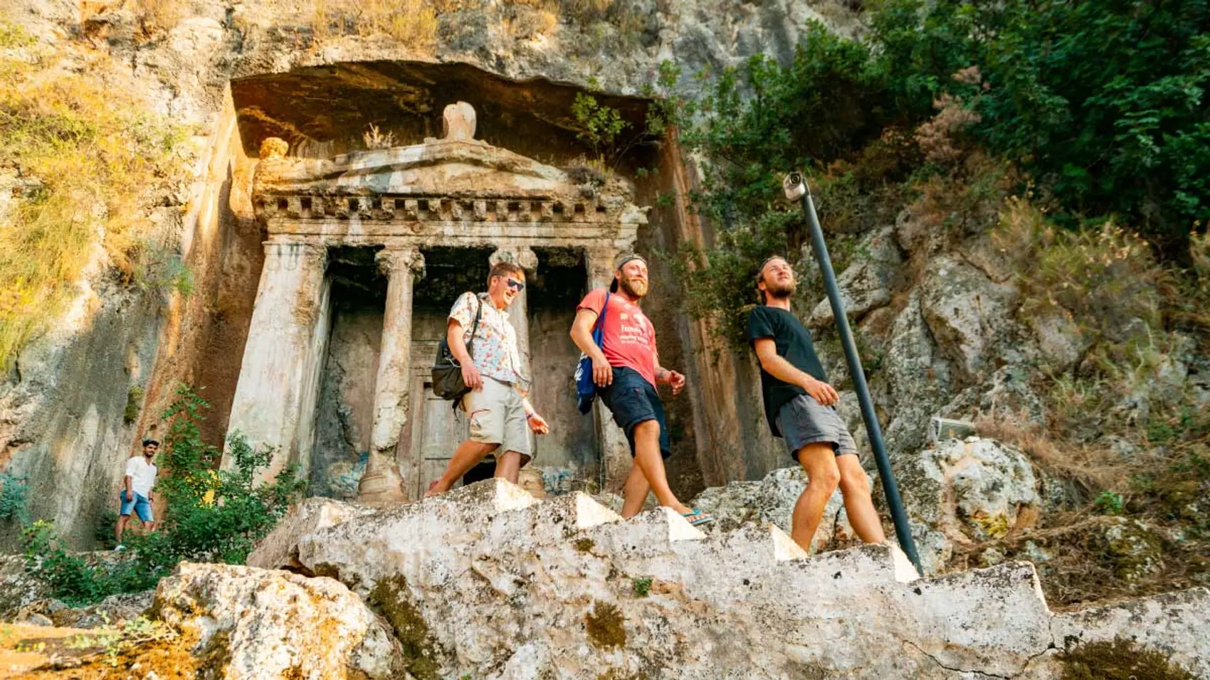 Group of people walk through Kayakoy ruins