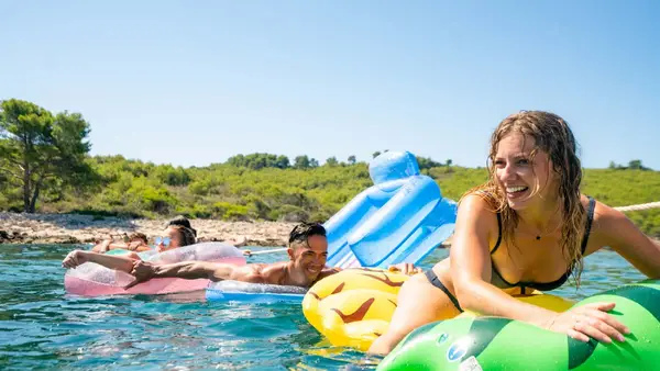 Friends on floaties in Croatia