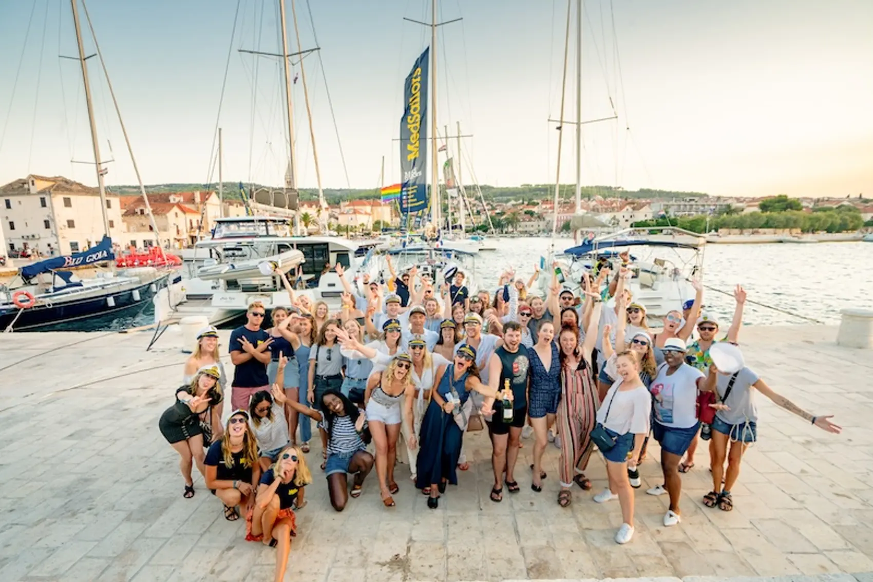 Photo of a group of people on a yacht week in Croatia during European music festivals having the best island hopping trip of their life.