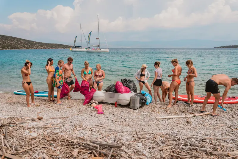 Group of people cleaning up plastic pollution on beaches in Croatia. 