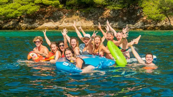 Friends play on floaties in Croatia