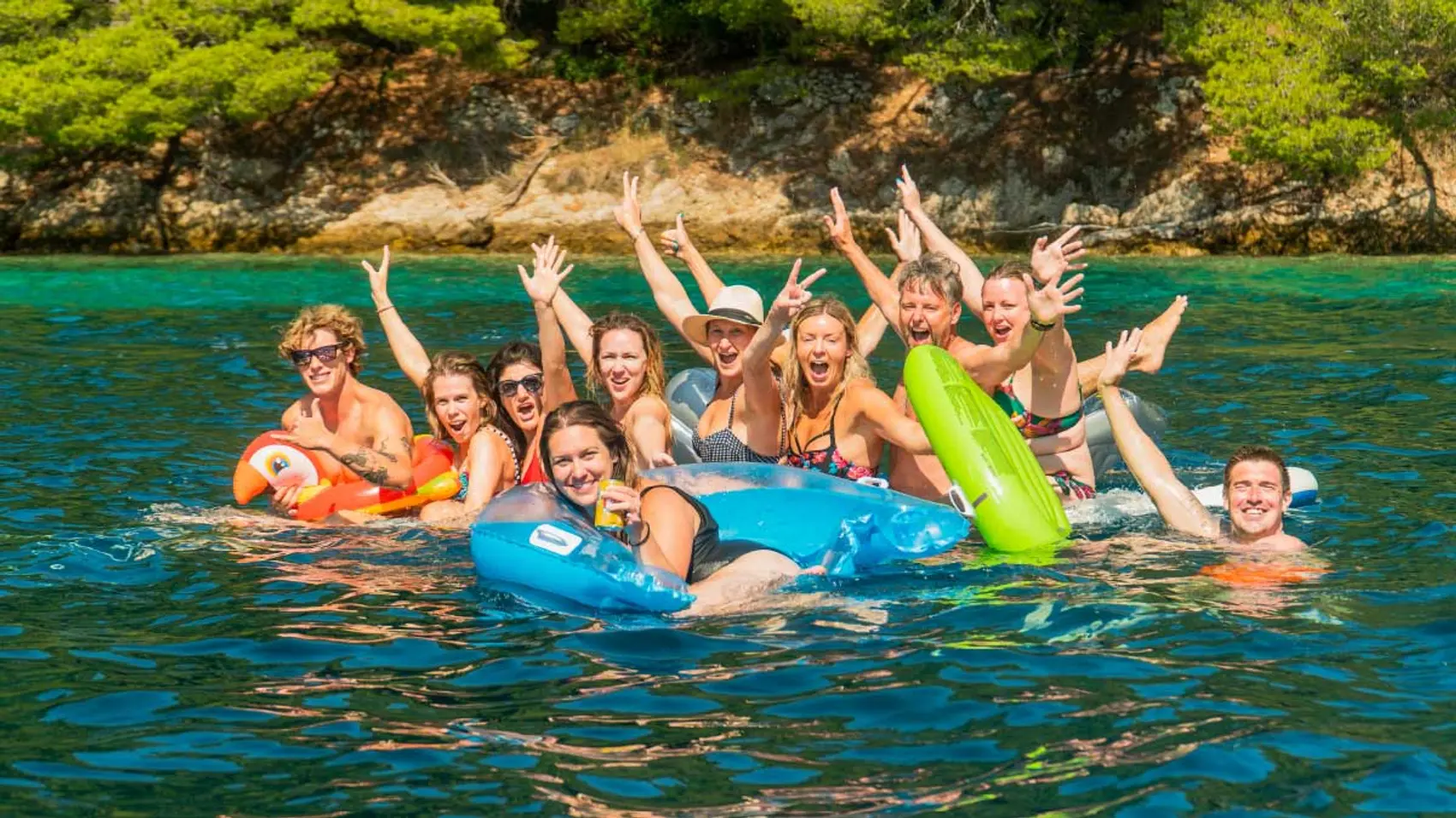 Friends play on floaties in Croatia